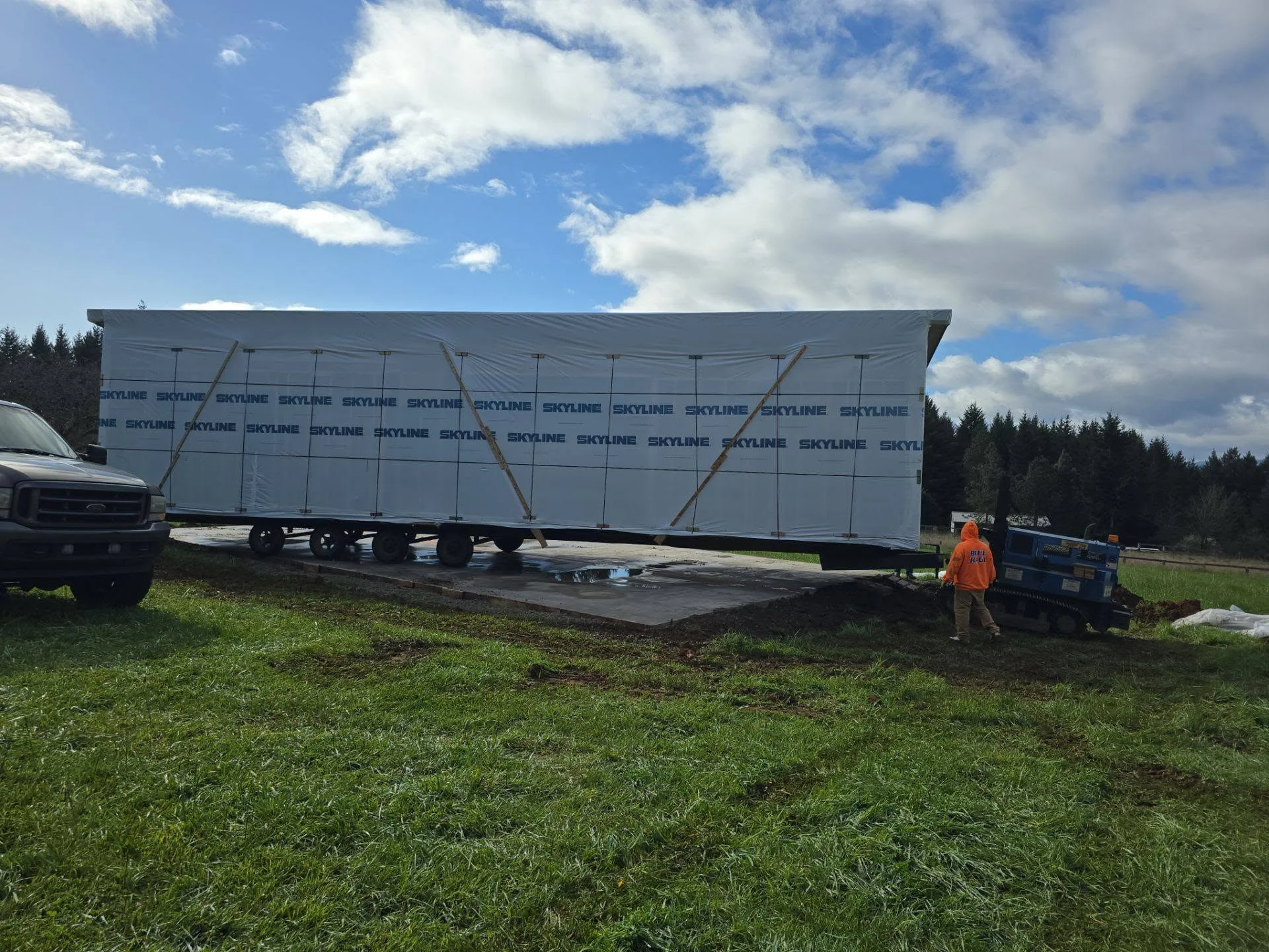 Concrete foundation pad with commercial trailer positioned on leveled ground